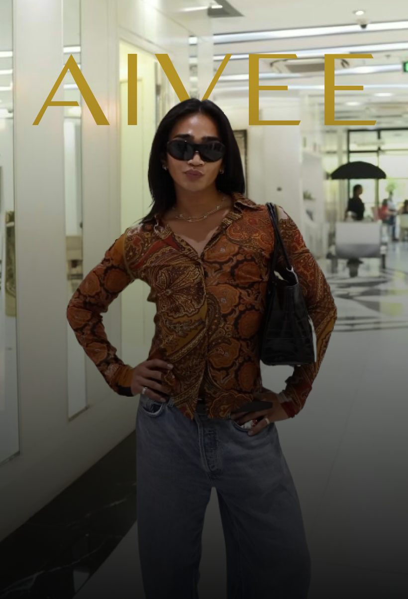 Bretman Rock posing with hands on hips in sunglasses, a paisley shirt and baggy jeans