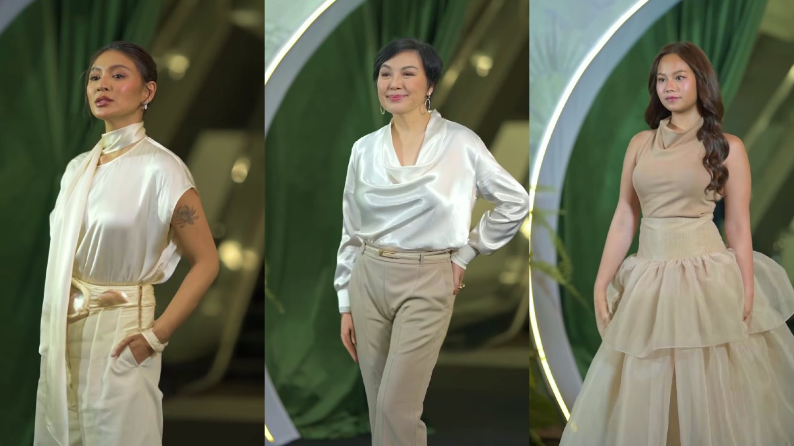 Three guests in cream and beige looks posing before the green-and-gold arch